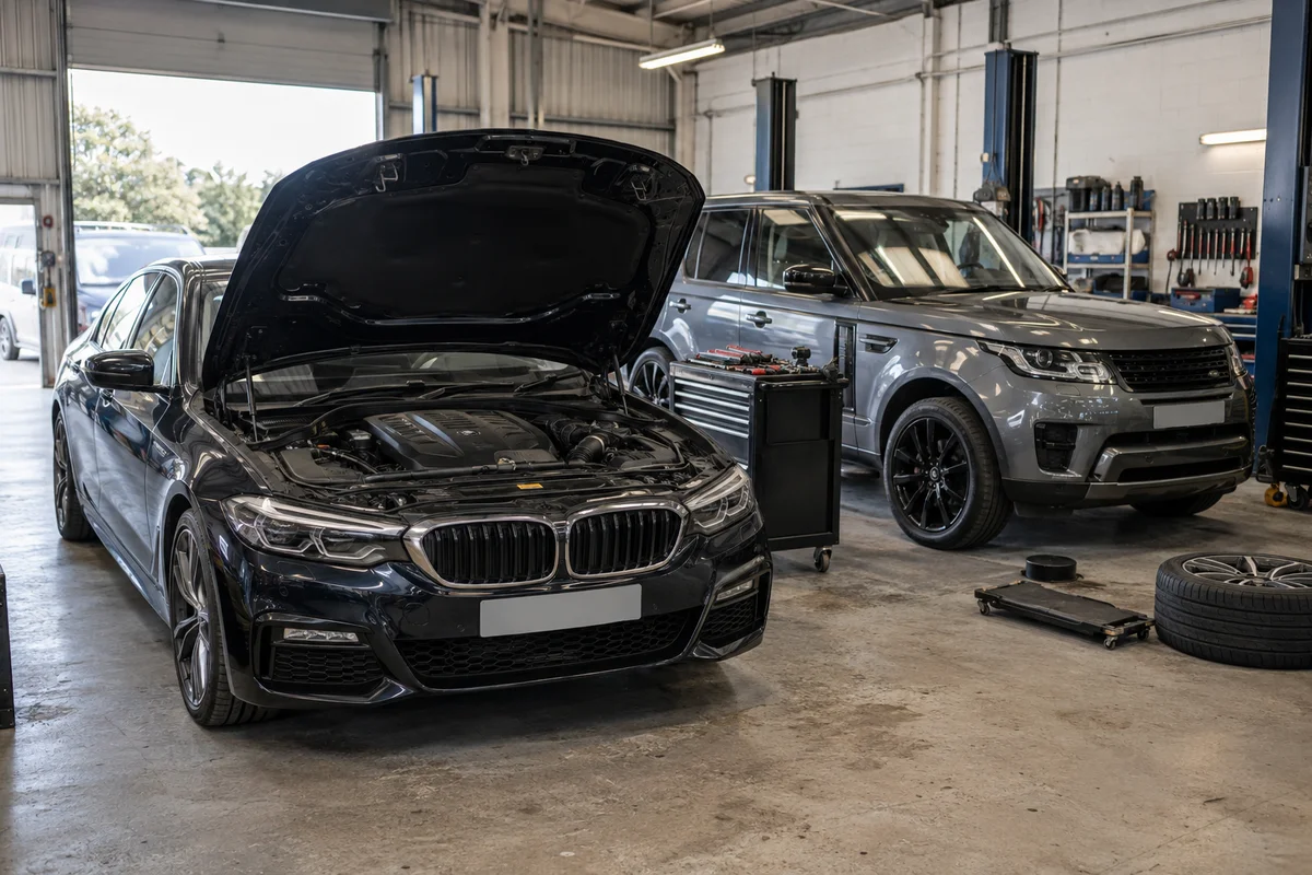 Illustrative car and SUV inside a vehicle workshop